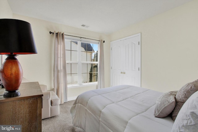 bedroom featuring a closet, visible vents, and carpet floors