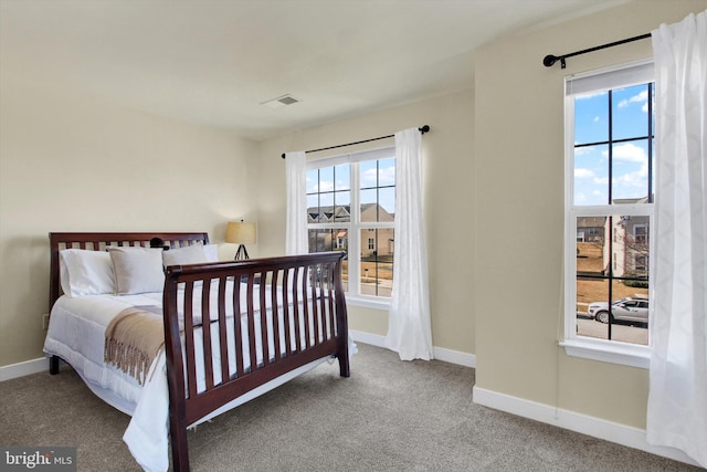 carpeted bedroom featuring visible vents and baseboards