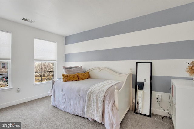 carpeted bedroom featuring visible vents and baseboards