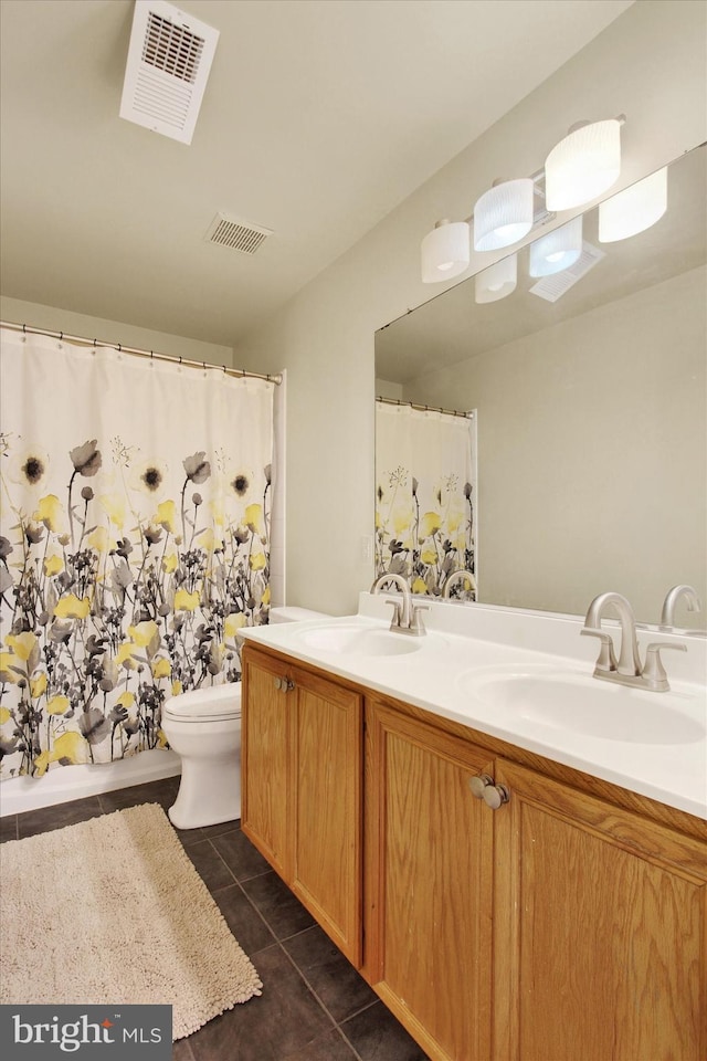 bathroom with tile patterned flooring, visible vents, and a sink