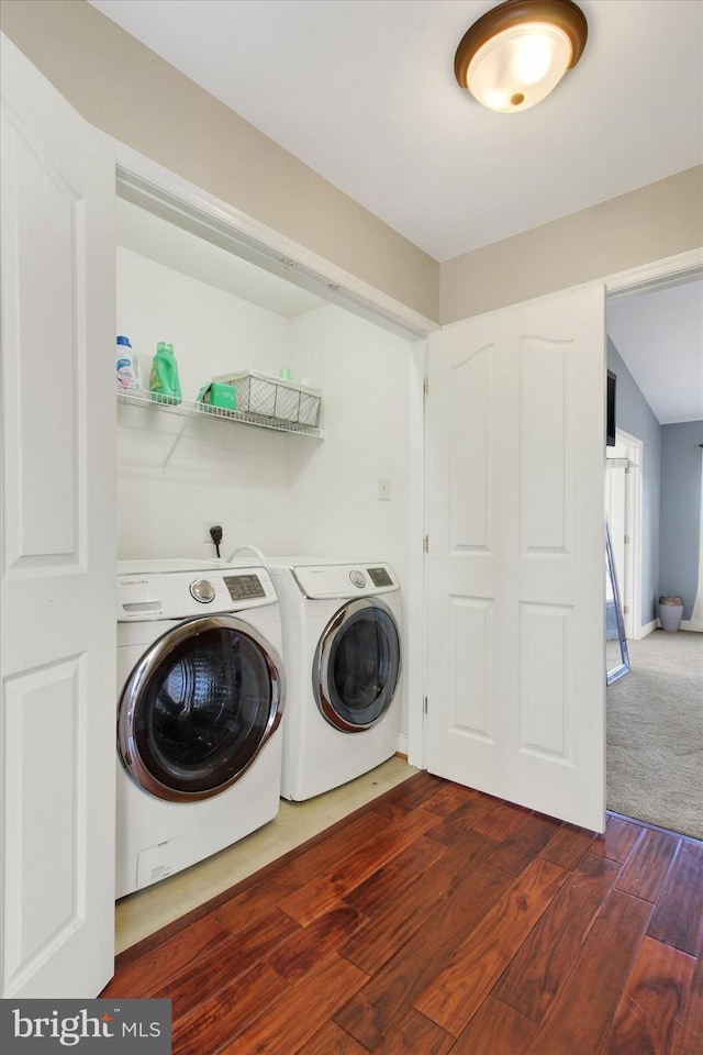 laundry area featuring laundry area, wood finished floors, independent washer and dryer, and baseboards