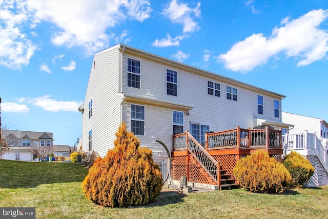 rear view of house featuring stairway, a wooden deck, and a yard