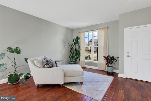 sitting room featuring baseboards and hardwood / wood-style flooring