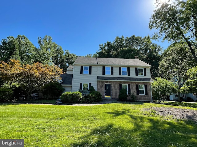 view of front of property with a front lawn and brick siding