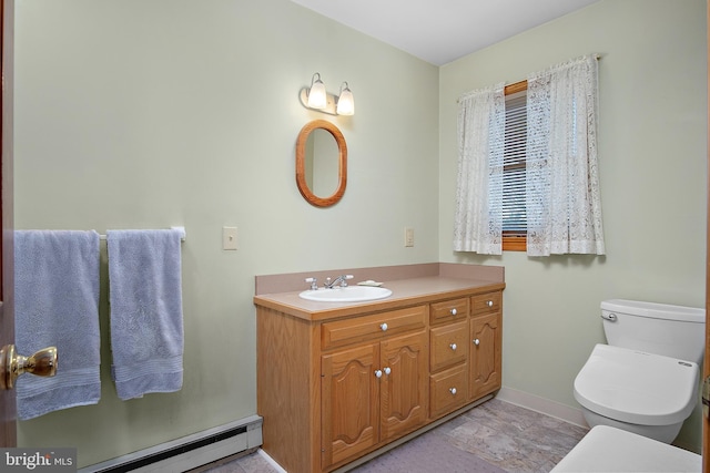 bathroom with a baseboard heating unit, vanity, toilet, and baseboards