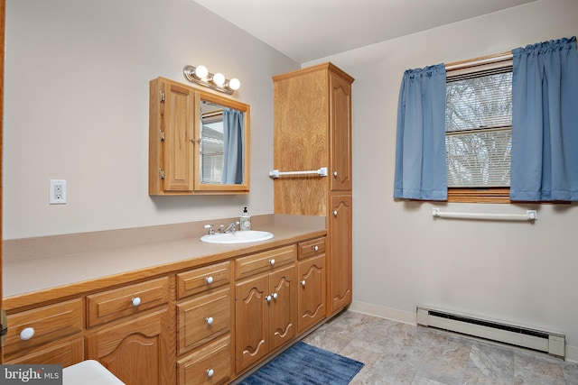 bathroom with a baseboard radiator, vanity, and baseboards