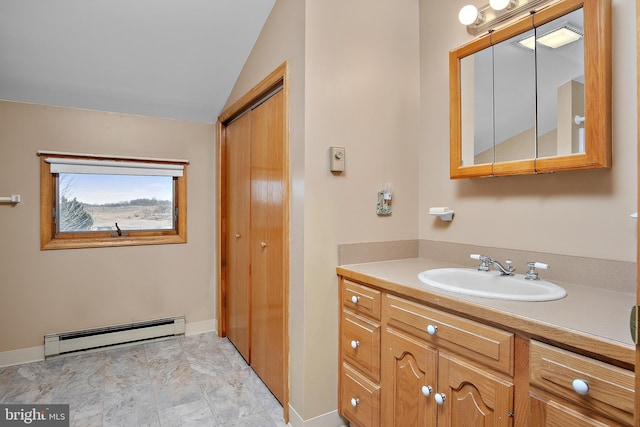 bathroom featuring vaulted ceiling, baseboards, baseboard heating, and vanity