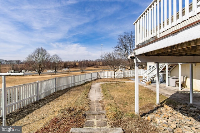 view of yard featuring a fenced backyard and stairway