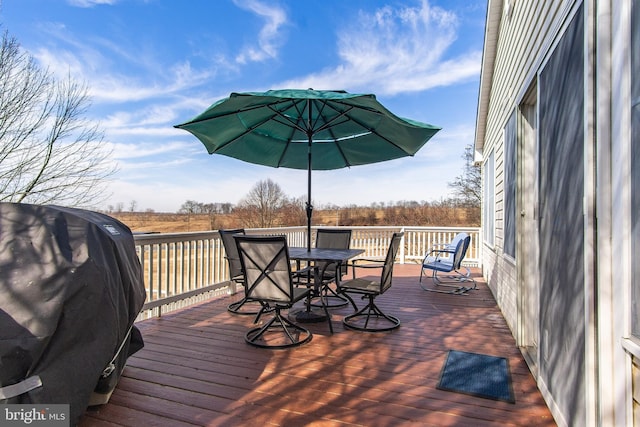 deck featuring outdoor dining space and grilling area