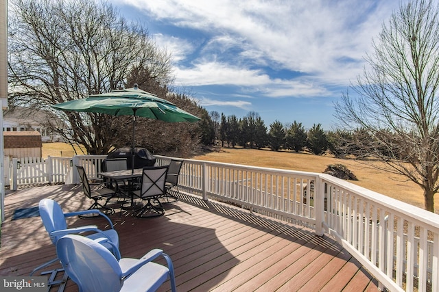 deck with grilling area and outdoor dining area