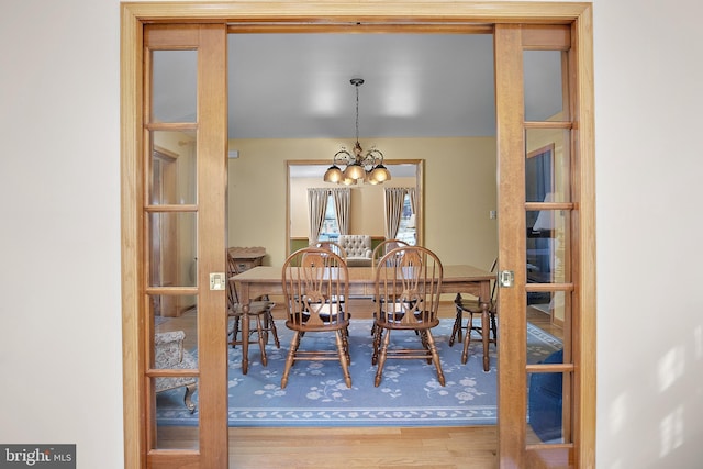 dining space featuring a chandelier and wood finished floors