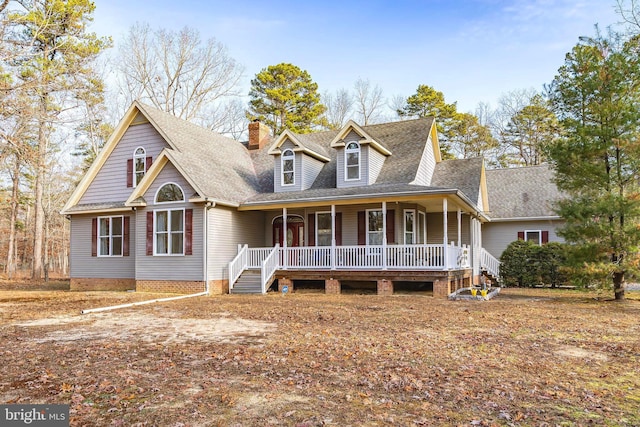 view of front of house with a shingled roof and a porch