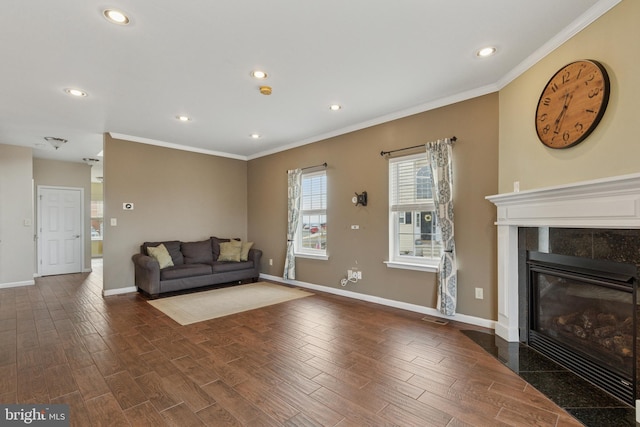 living room with baseboards, dark wood finished floors, crown molding, a fireplace, and recessed lighting