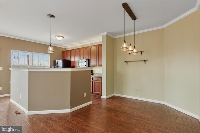 kitchen featuring ornamental molding, black refrigerator, dark wood finished floors, and brown cabinets