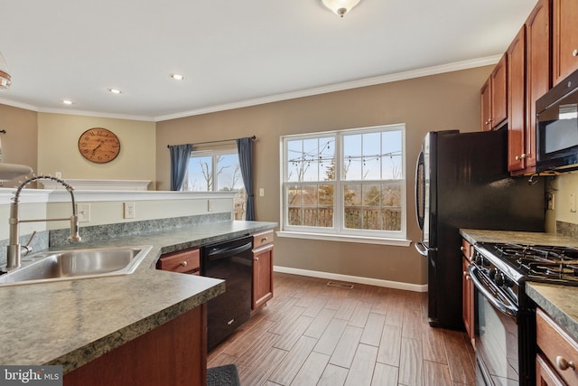 kitchen featuring ornamental molding, baseboards, a sink, and black appliances