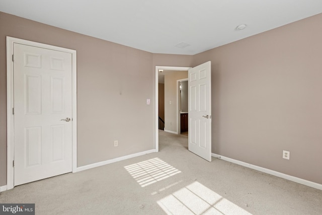 unfurnished bedroom with carpet floors and baseboards