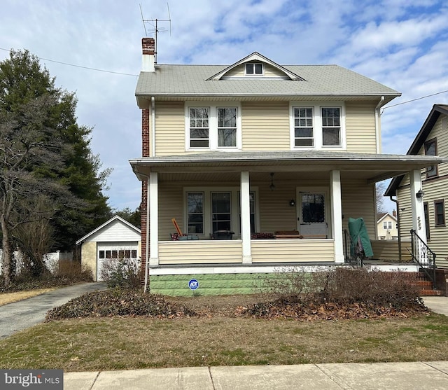 traditional style home featuring covered porch, a chimney, an outdoor structure, and a garage