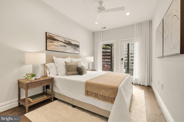 bedroom featuring access to exterior, wood finished floors, visible vents, and recessed lighting