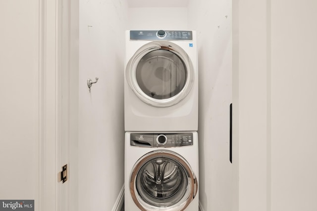 laundry area with stacked washing maching and dryer and laundry area