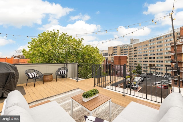 deck with outdoor lounge area and a grill