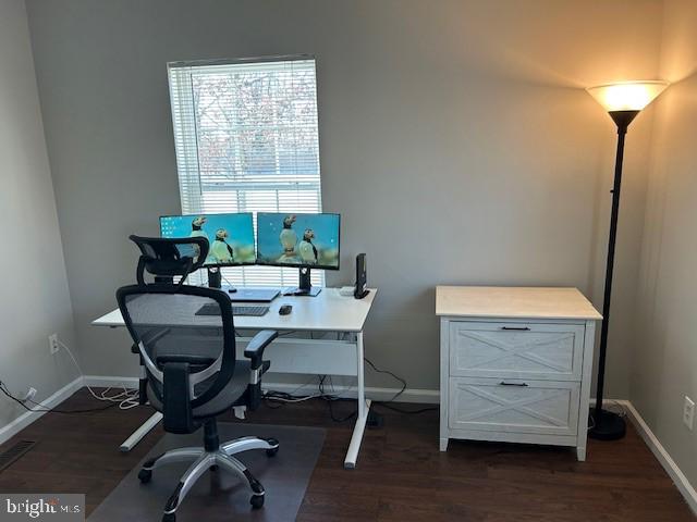 home office featuring dark wood-style flooring and baseboards