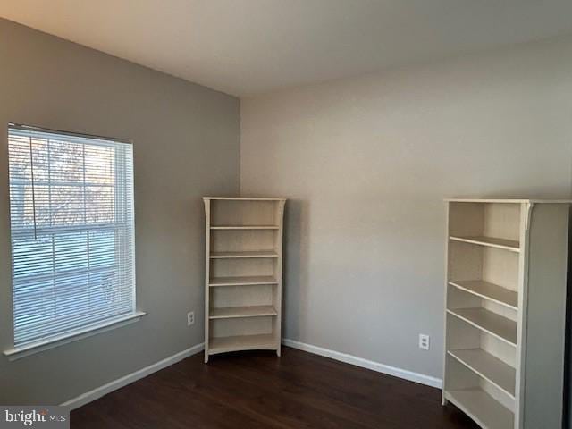 unfurnished bedroom featuring baseboards and wood finished floors