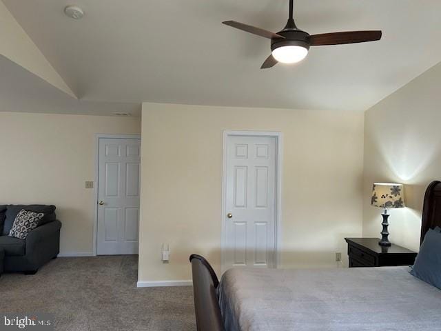 carpeted bedroom featuring ceiling fan, vaulted ceiling, and baseboards