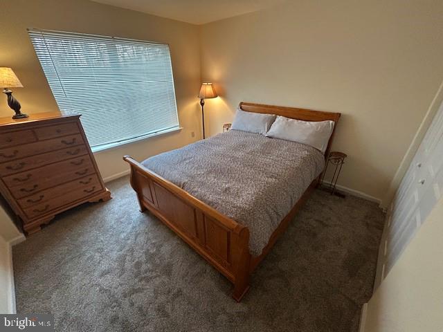 bedroom with carpet flooring and baseboards