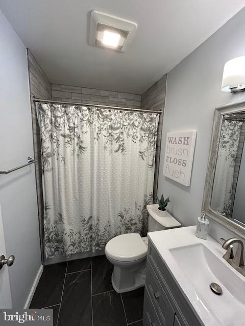 bathroom featuring curtained shower, toilet, visible vents, vanity, and marble finish floor