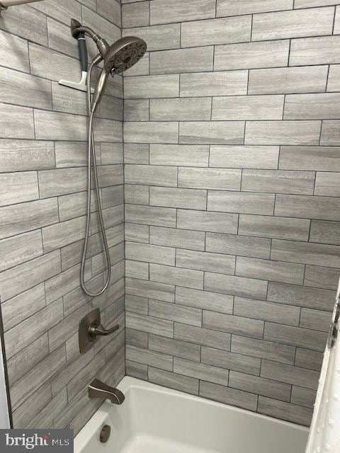 bathroom with shower / bath combo with shower curtain