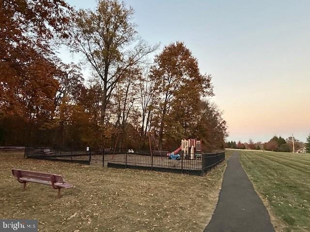 surrounding community featuring a yard, playground community, and fence