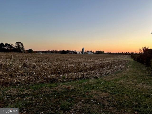 nature at dusk featuring a rural view