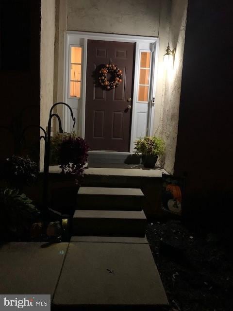 entrance to property featuring stucco siding