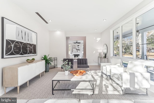 living room featuring recessed lighting, visible vents, a fireplace, and ceiling fan