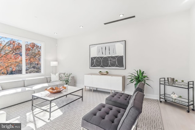 living room featuring baseboards, wood finished floors, and recessed lighting