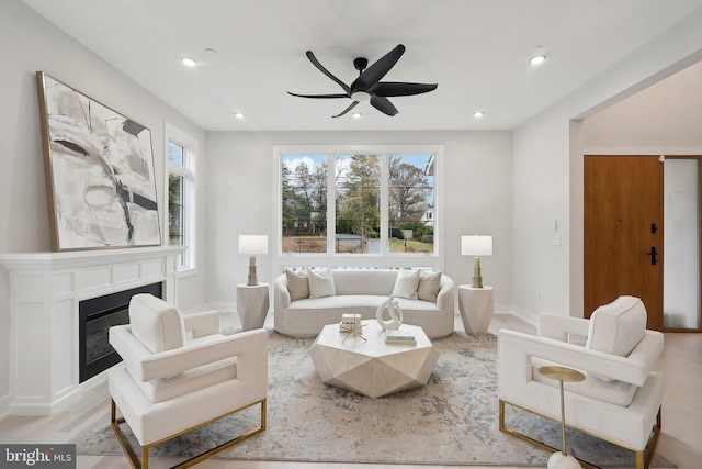 living room featuring recessed lighting, plenty of natural light, ceiling fan, and a glass covered fireplace