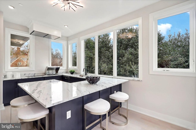 interior space featuring baseboards, black electric cooktop, light wood-style floors, a sink, and recessed lighting