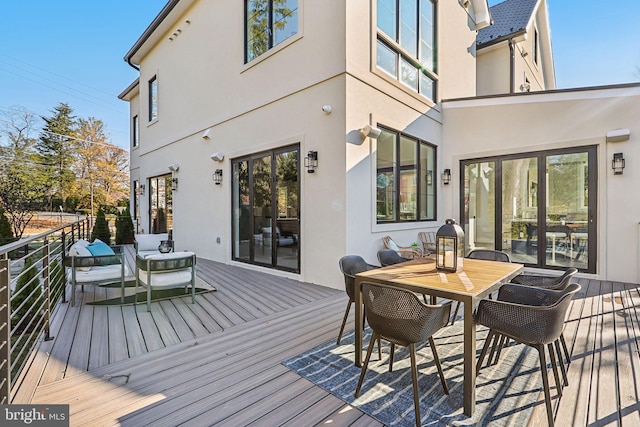 wooden deck featuring outdoor dining space