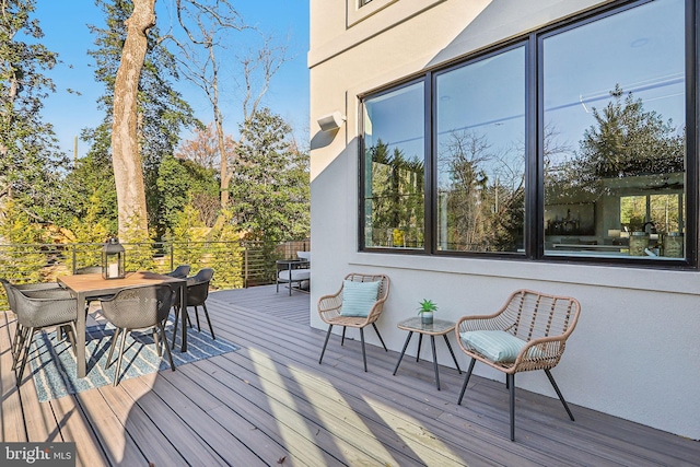 wooden deck featuring outdoor dining space