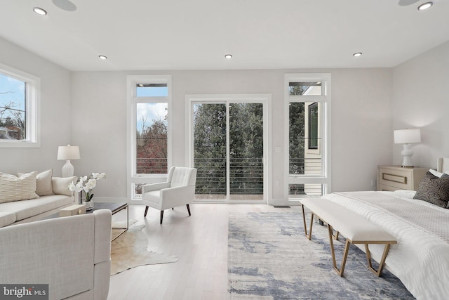 bedroom featuring baseboards, access to outside, wood finished floors, and recessed lighting