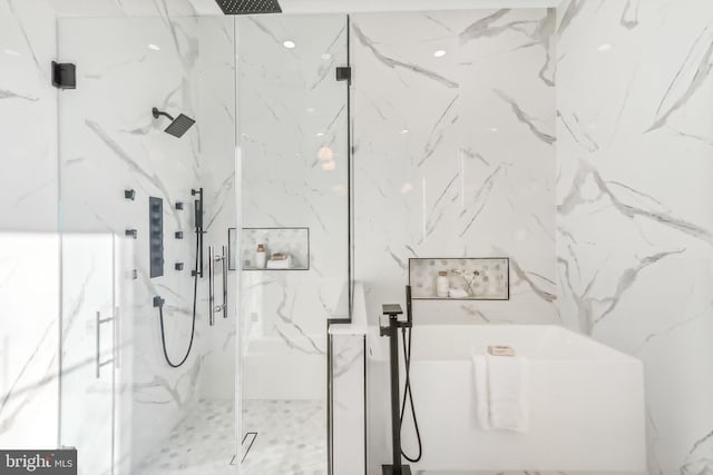 bathroom featuring a marble finish shower