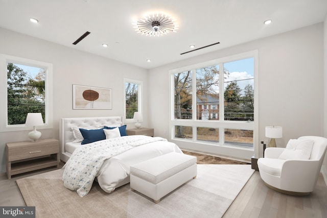 bedroom with wood finished floors and recessed lighting