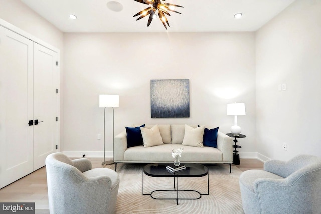 living room with light wood-style floors, baseboards, and recessed lighting