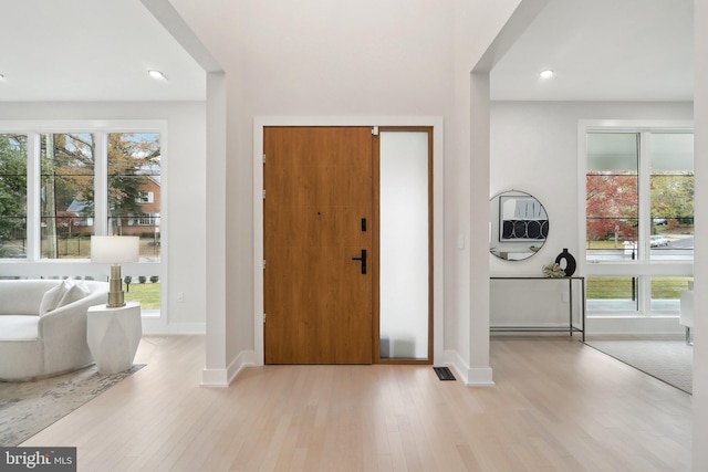 entryway with recessed lighting, wood finished floors, and baseboards