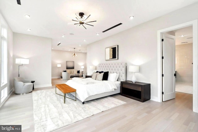 bedroom with a notable chandelier, baseboards, wood finished floors, and recessed lighting