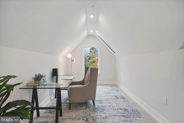 office space featuring lofted ceiling and baseboards