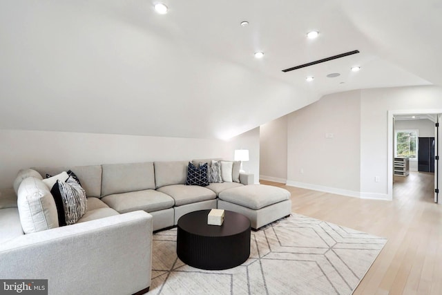 living area featuring vaulted ceiling, recessed lighting, baseboards, and light wood-style floors