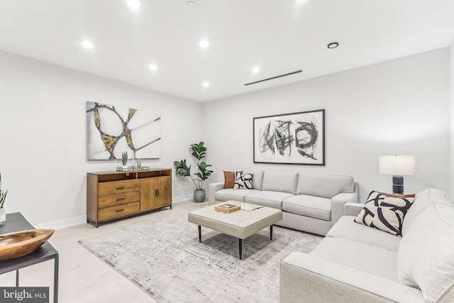 living room featuring recessed lighting and baseboards