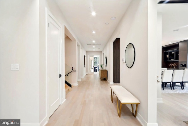 hallway featuring recessed lighting, light wood-type flooring, and baseboards