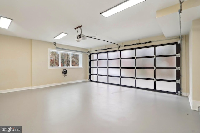 garage with baseboards and a garage door opener